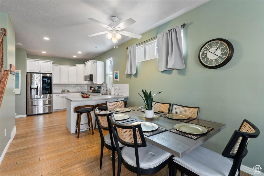 Dining room with ceiling fan, light wood-type flooring, and recessed lighting