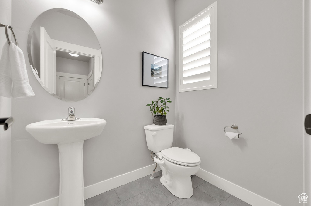 Bathroom with toilet and tile patterned floors