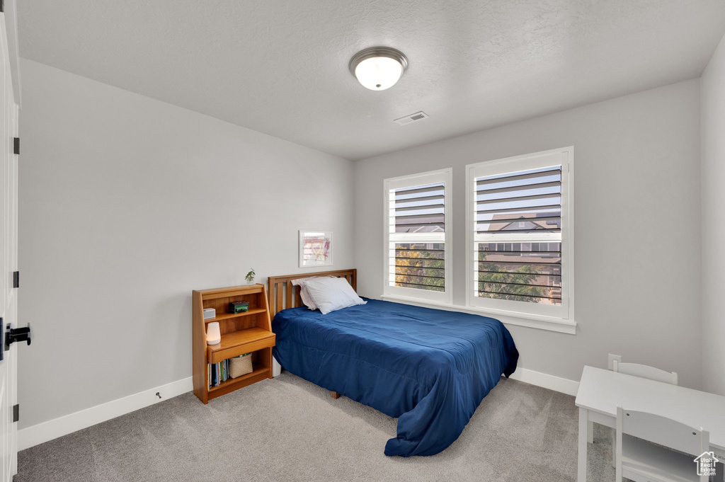 Carpeted bedroom with baseboards