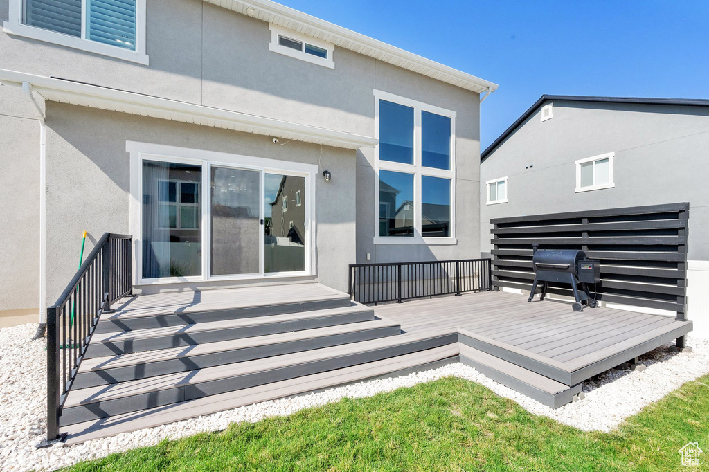 Back of property featuring stucco siding and a deck