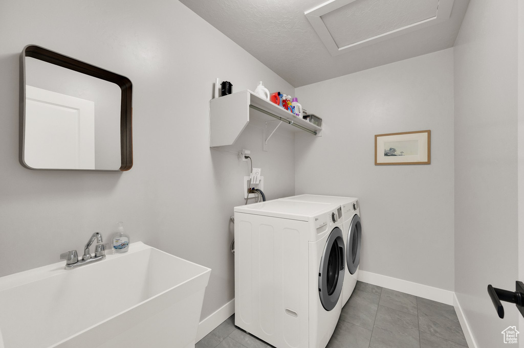 Washroom featuring independent washer and dryer and attic access