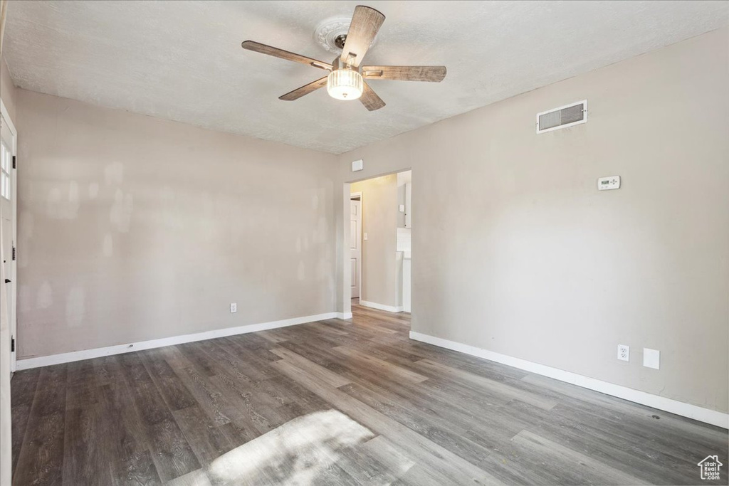Spare room with a ceiling fan and wood finished floors