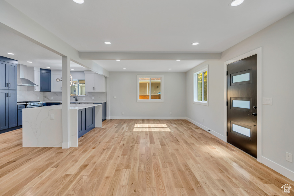 Unfurnished living room with light wood finished floors and recessed lighting