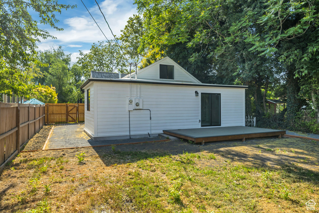 Rear view of property with a deck and a fenced backyard
