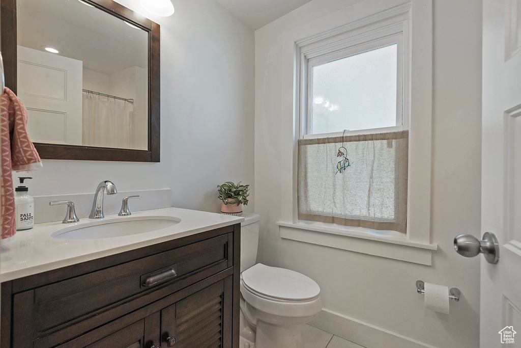 Full bath with vanity and tile patterned floors