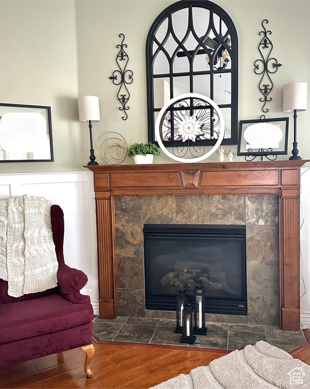 Detailed view of wood finished floors and a tiled fireplace