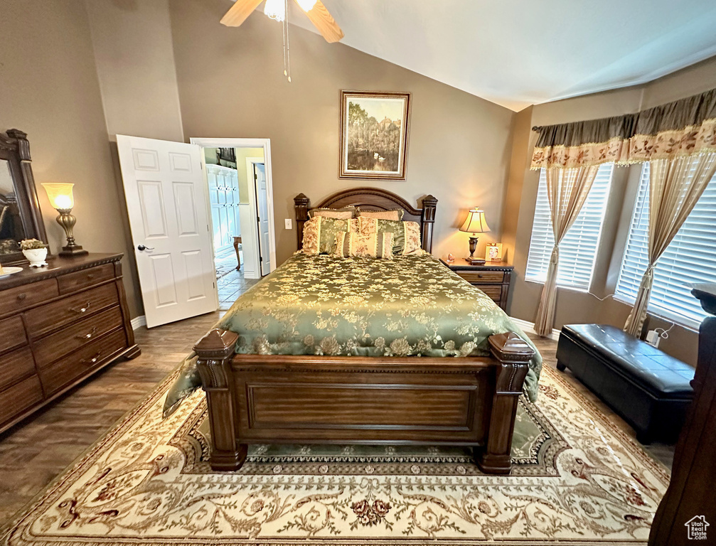 Bedroom with lofted ceiling, dark wood finished floors, and a ceiling fan