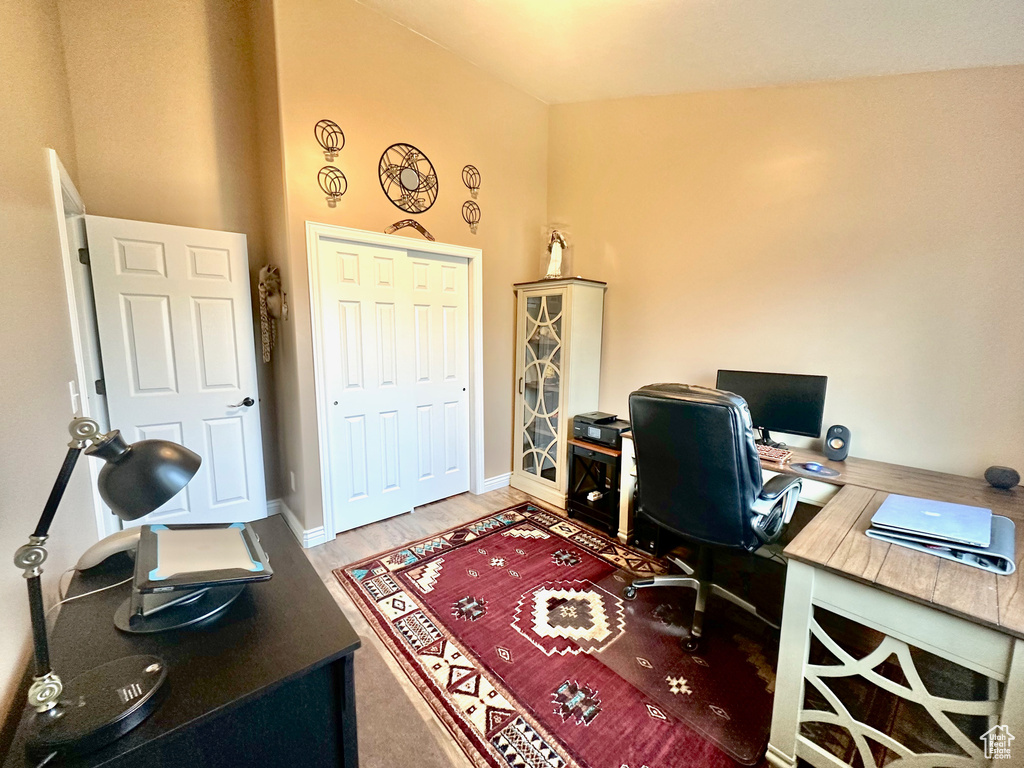Office space featuring baseboards and light wood finished floors