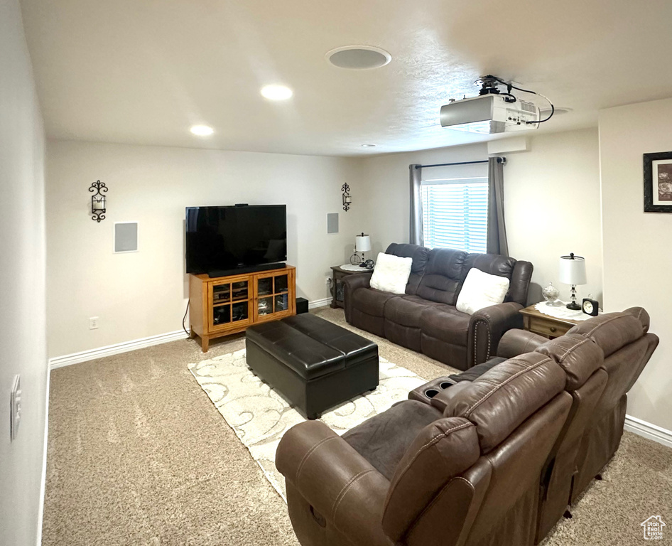 Living area with carpet floors and recessed lighting