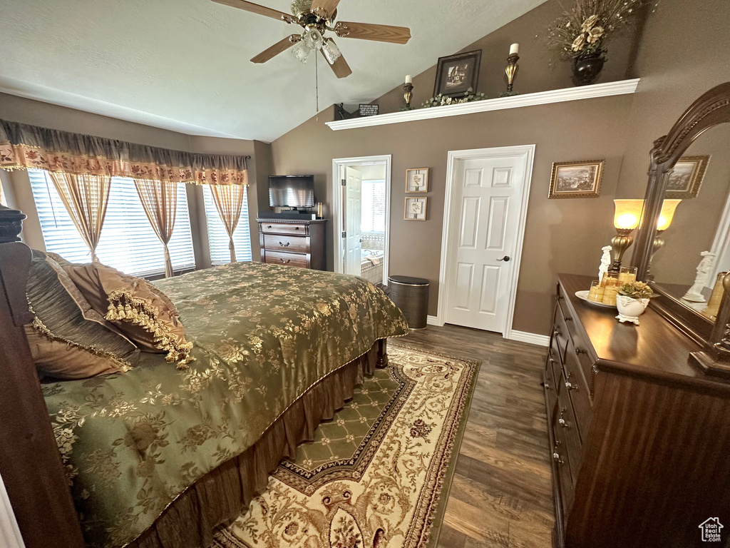 Bedroom featuring vaulted ceiling, dark wood-style flooring, and ceiling fan