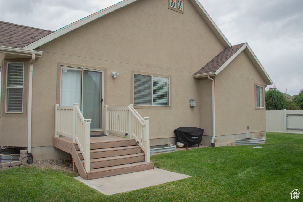 Rear view of property featuring stucco siding and roof with shingles