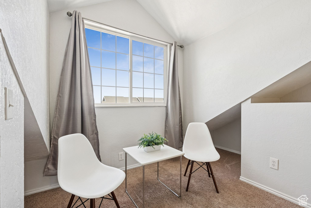 Sitting room featuring carpet and lofted ceiling