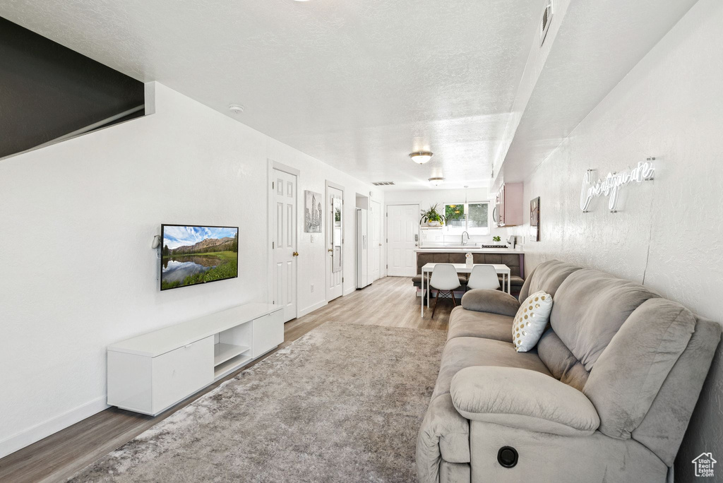 Living area with light wood-style floors and baseboards
