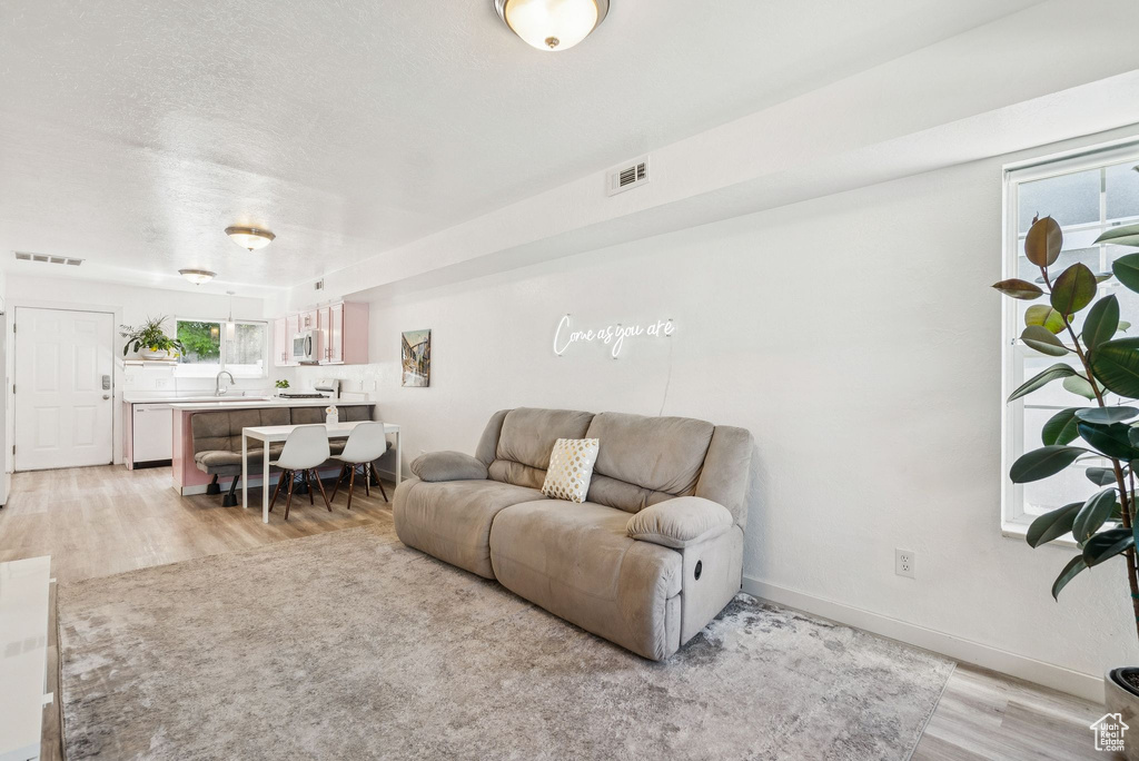 Living area featuring light wood-type flooring and baseboards