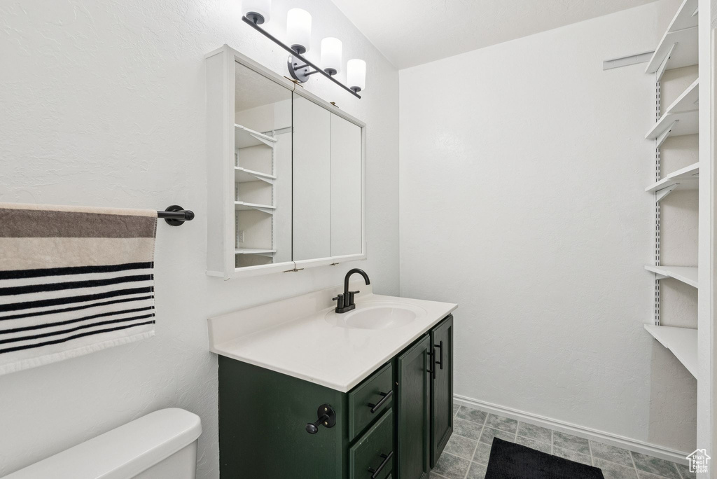 Bathroom featuring vanity and toilet