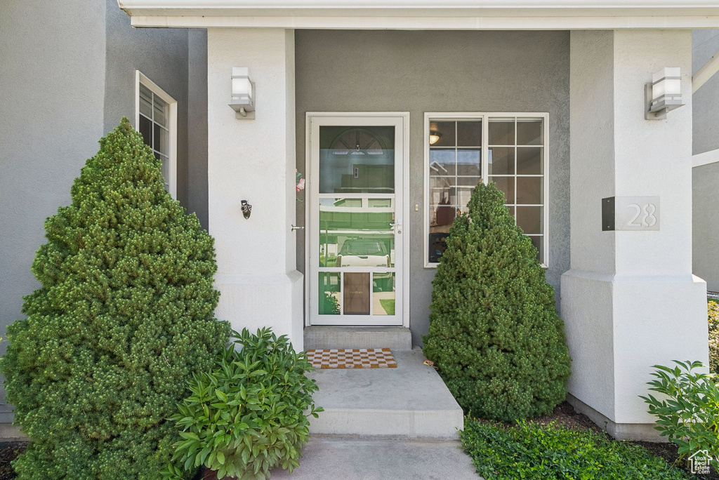View of exterior entry featuring stucco siding