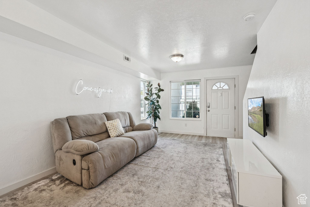Living room featuring baseboards and light wood-style flooring