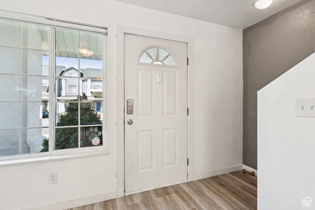 Entryway featuring wood finished floors and baseboards