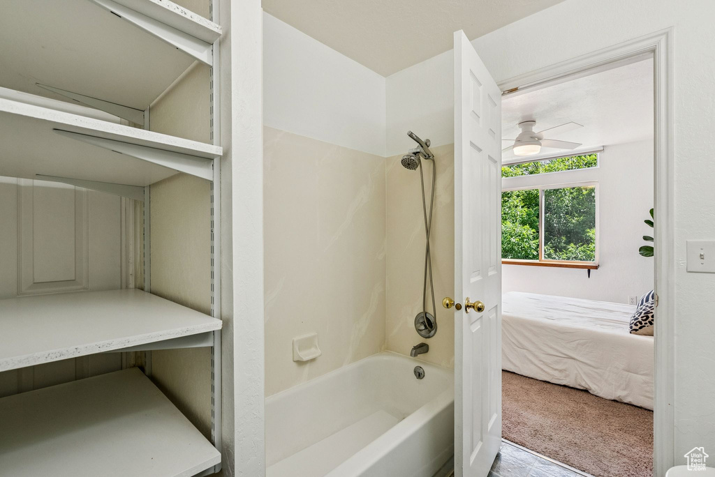 Bathroom featuring shower / bathtub combination, ceiling fan, and ensuite bathroom