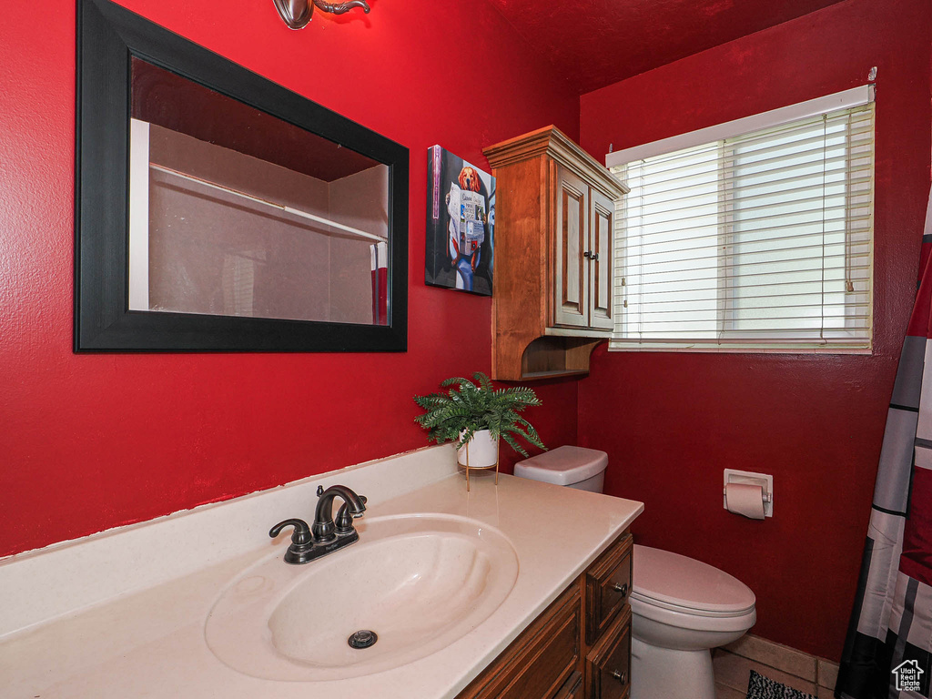 Full bathroom with a shower with curtain, vanity, and tile patterned floors