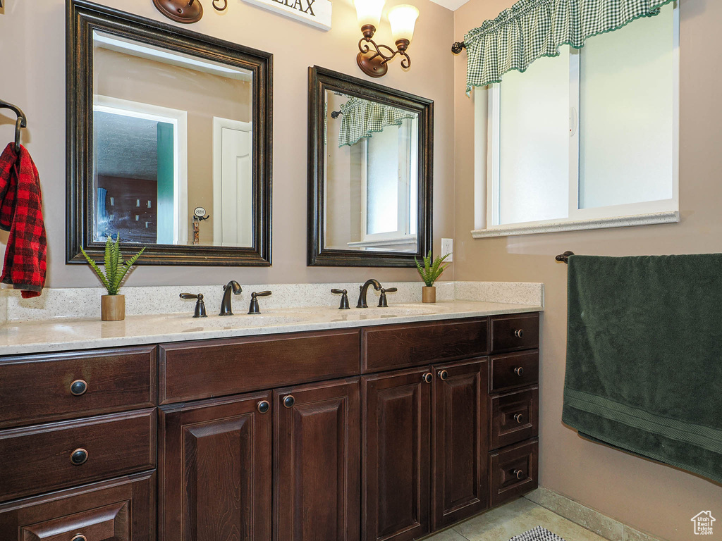 Bathroom featuring double vanity and tile patterned floors