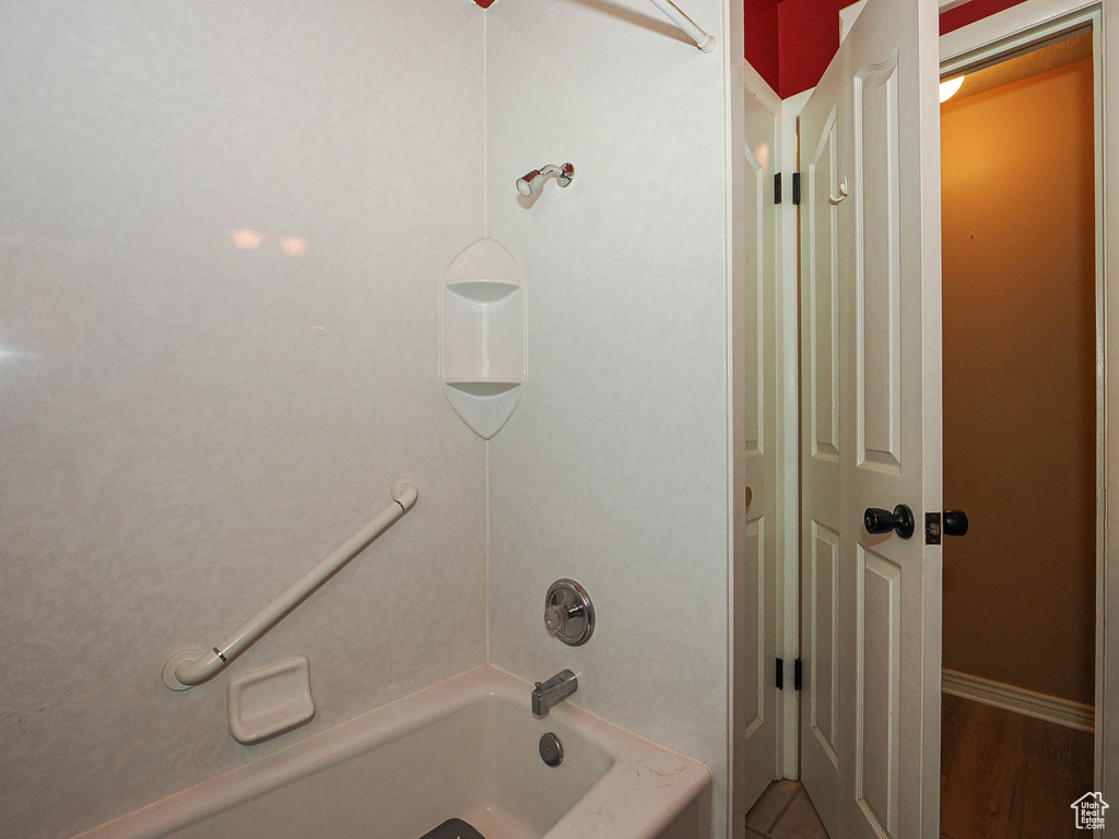 Full bath featuring shower / washtub combination