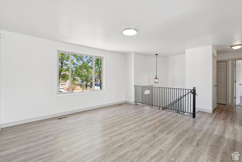 Empty room with light wood-type flooring and baseboards