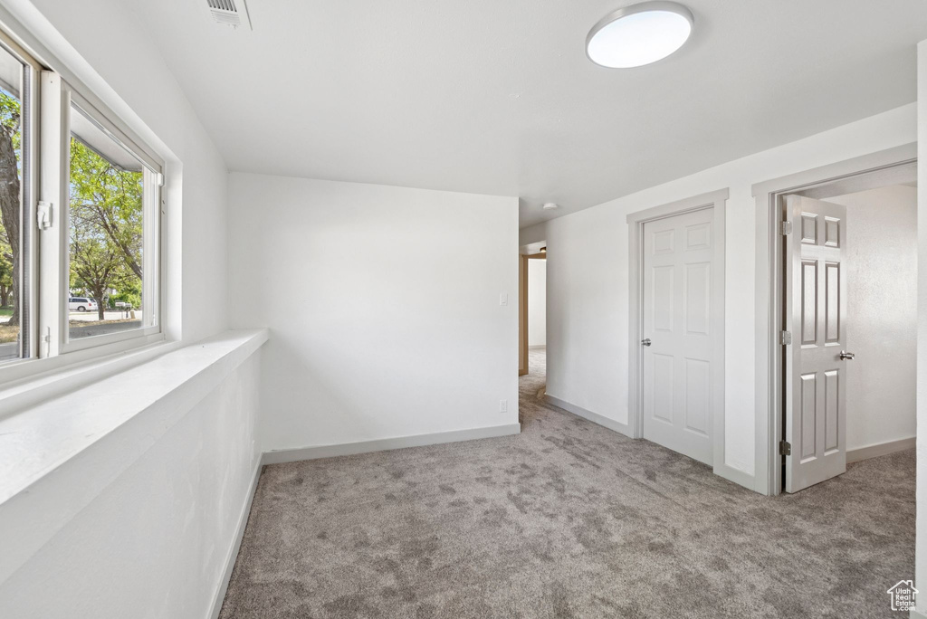 Unfurnished bedroom with carpet and baseboards