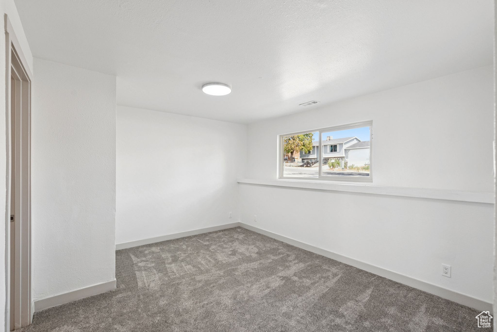 Unfurnished room with carpet and baseboards