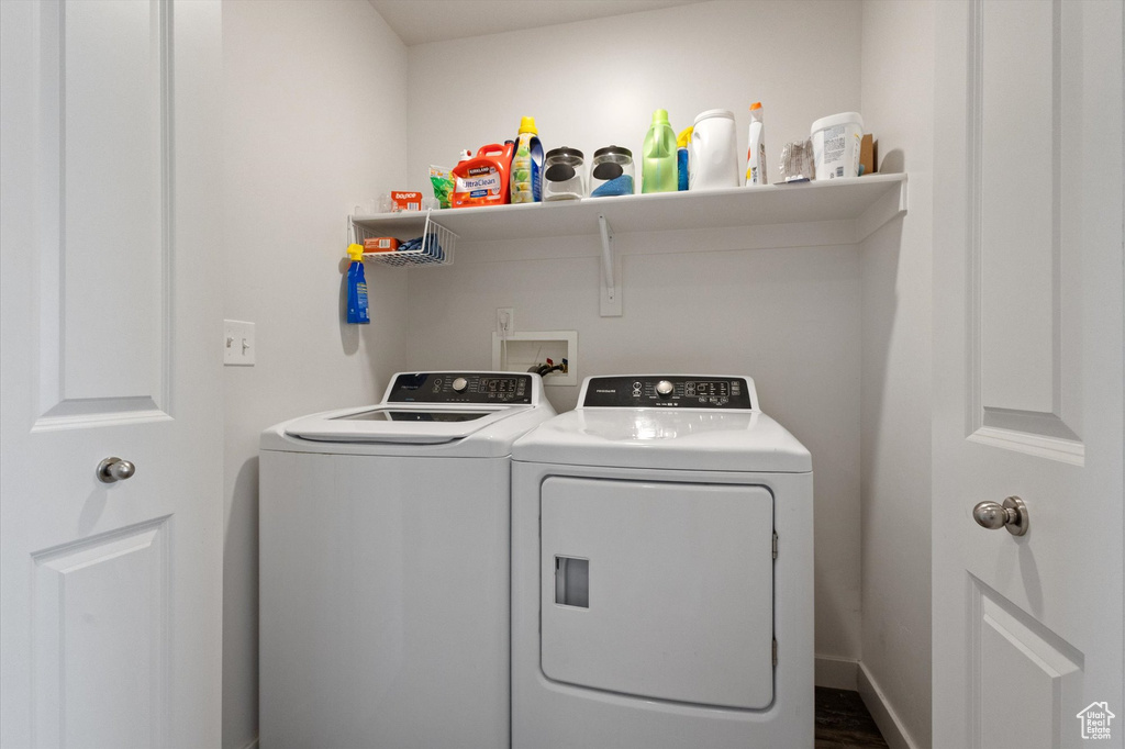 Laundry room with washing machine and dryer and dark wood-style floors