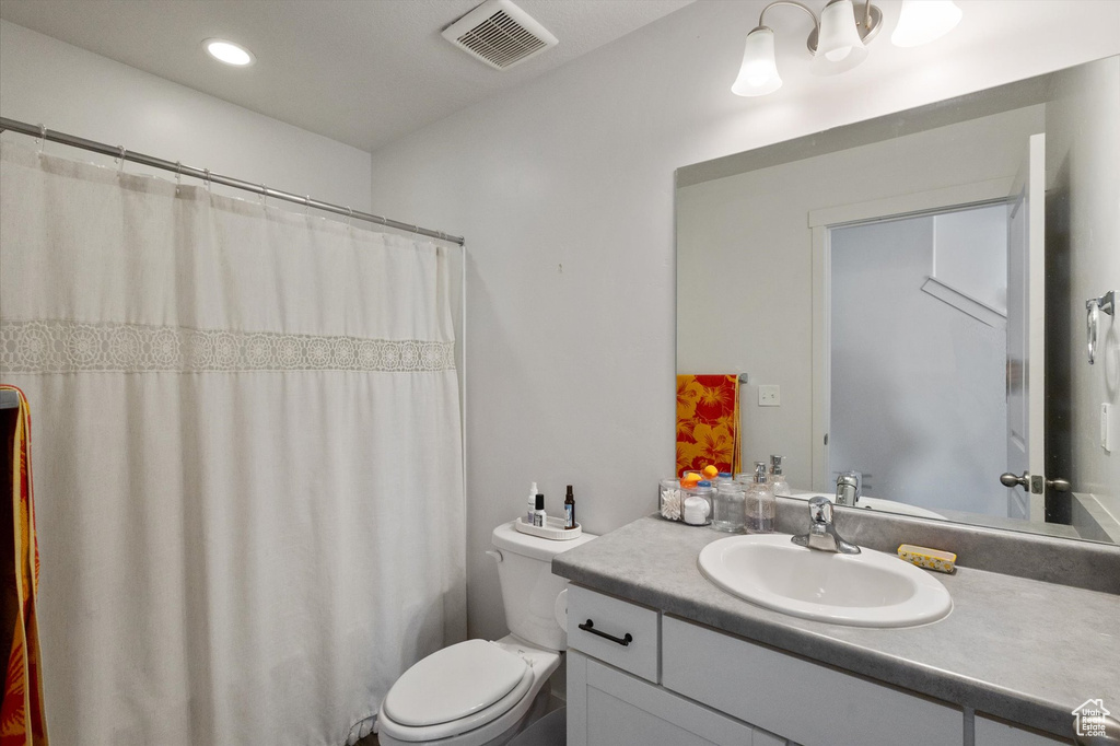 Full bathroom with vanity, a shower with curtain, and recessed lighting