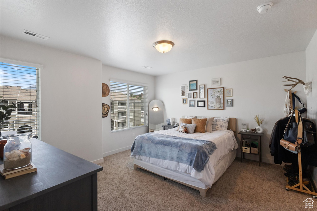 Carpeted bedroom with baseboards