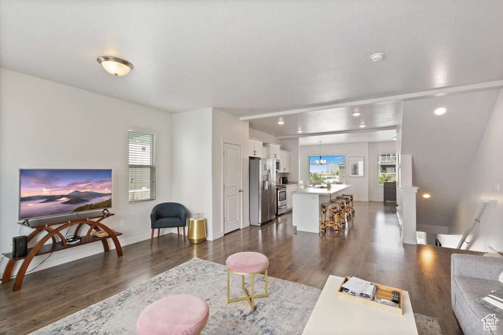 Living room featuring dark wood-style floors and recessed lighting