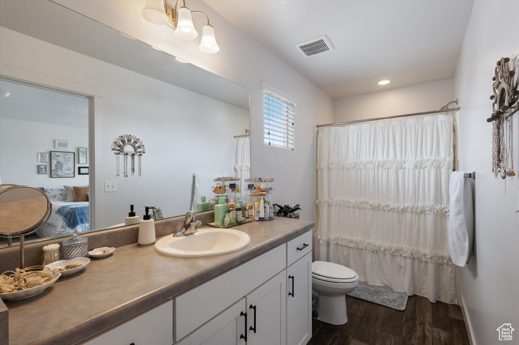 Ensuite bathroom featuring wood finished floors, vanity, recessed lighting, and a shower with shower curtain