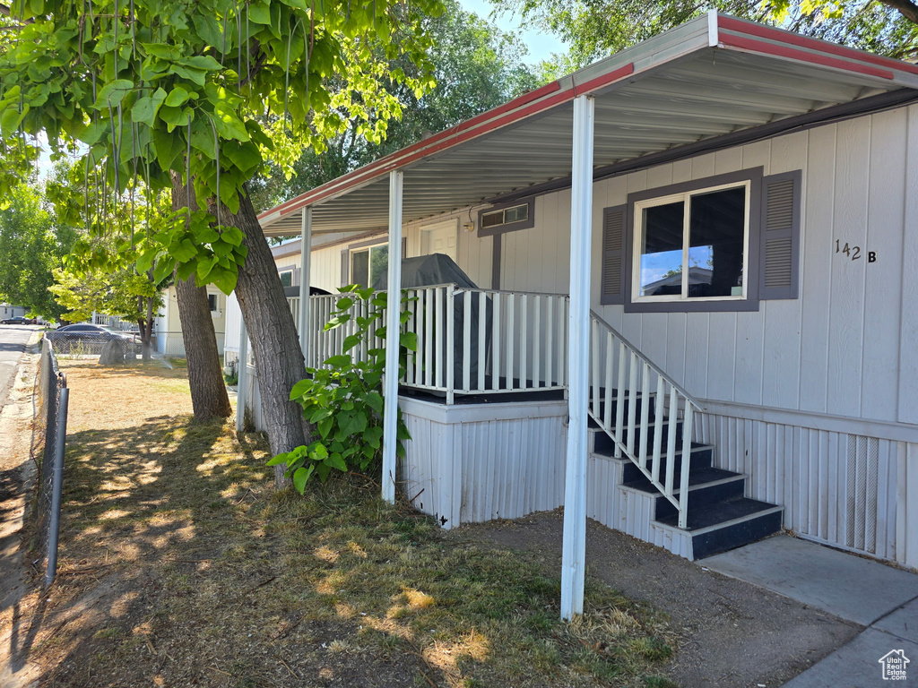 View of side of home featuring a porch