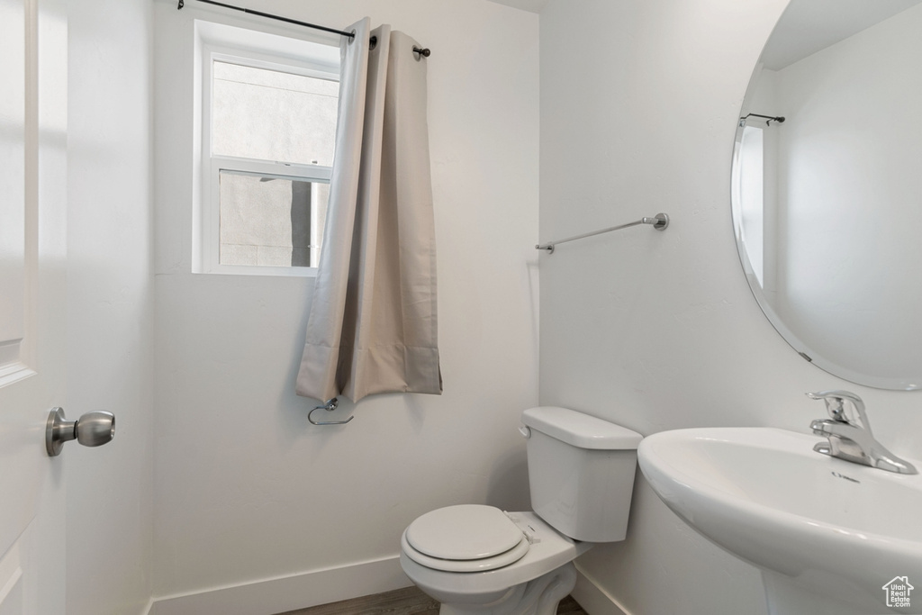 Bathroom with toilet and baseboards