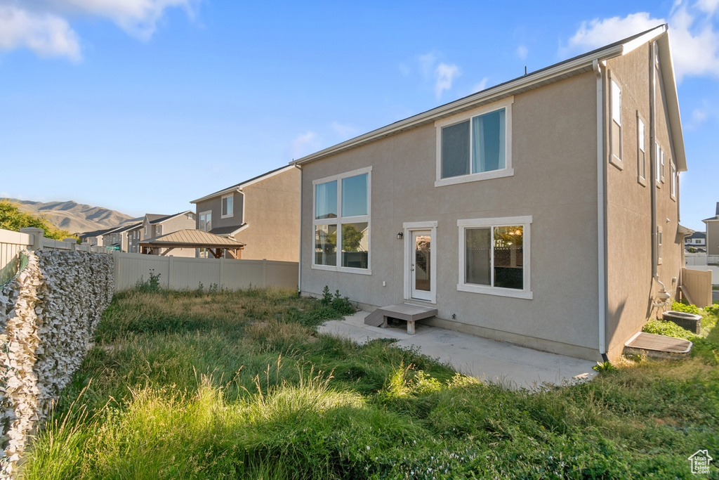 Rear view of property with stucco siding and a patio