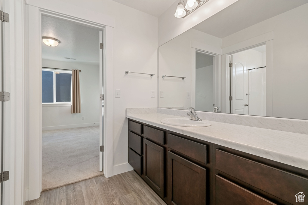 Bathroom featuring vanity and wood finished floors