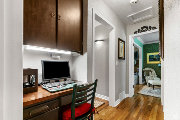 Office with wood finished floors and attic access