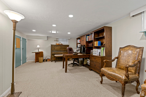 Home office with light colored carpet, recessed lighting, and a textured ceiling