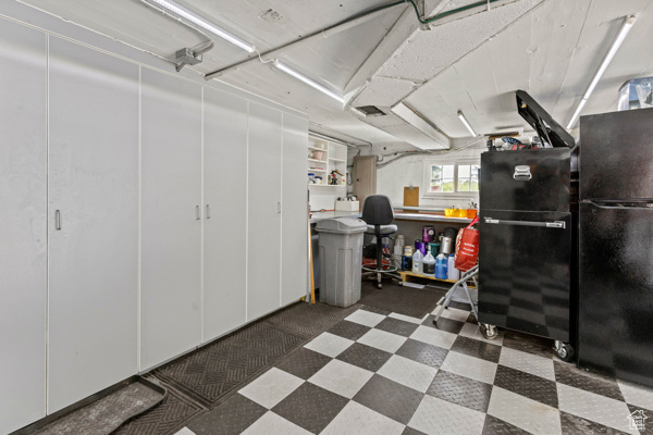 Garage featuring freestanding refrigerator