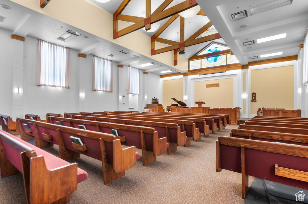 Misc room with carpet flooring, high vaulted ceiling, and beamed ceiling