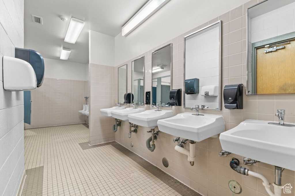 Bathroom with tile walls and tile patterned flooring