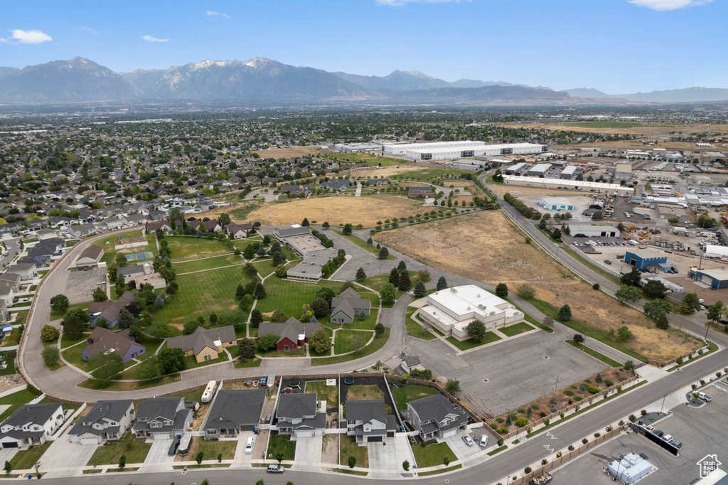Aerial view of property's location featuring a mountain backdrop and nearby suburban area