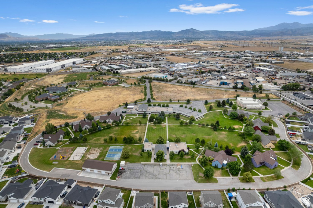 Aerial view of property's location with mountains and nearby suburban area