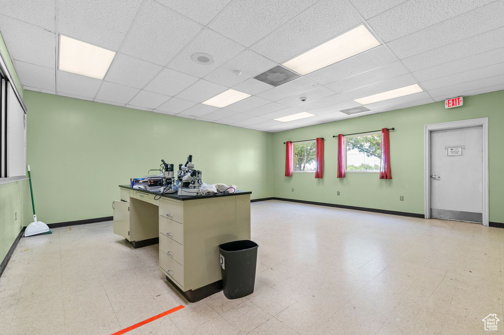 Unfurnished office featuring light flooring and a paneled ceiling