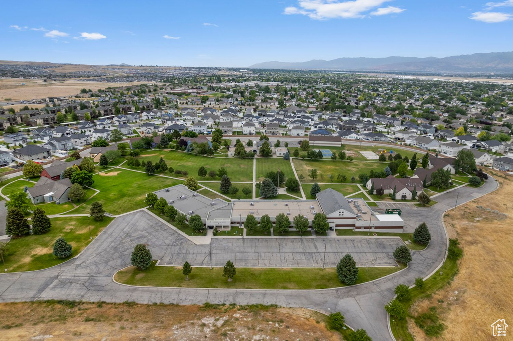 Aerial view of property's location with a mountain backdrop and nearby suburban area