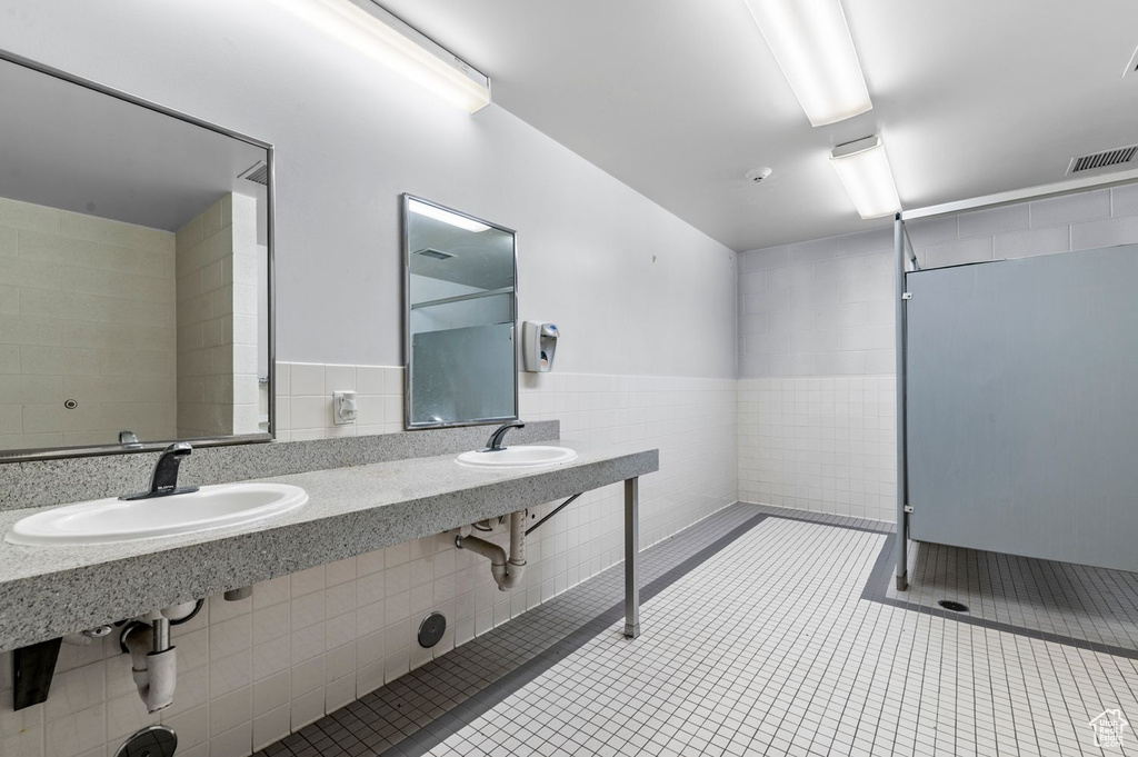 Full bathroom with tile walls and tile patterned floors