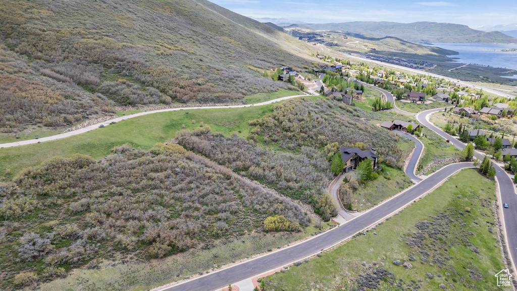 Aerial view of property's location with a water and mountain view