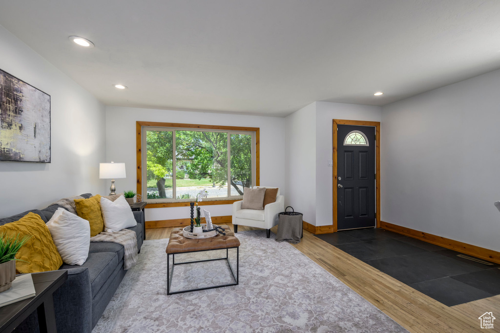 Living area with wood finished floors and recessed lighting